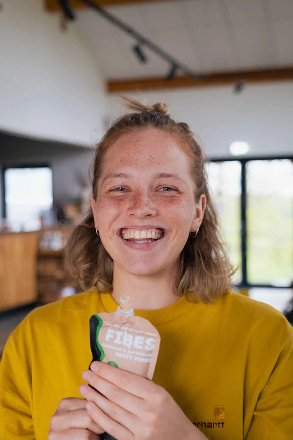 Person holding Fibes puree in an indoor setting